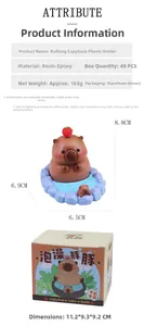 Detail view of resin capybara phone stand with dimensions and product packaging