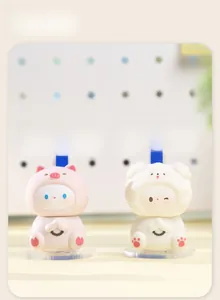 Macro shot of cute pink pig and white pet desktop figurines with prayer beads