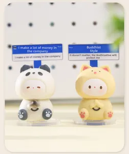 Detail of Zen panda and cat figurines with praying hands and humorous wooden office signs