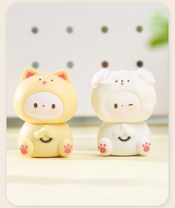 Macro detail of cute praying resin figurines in yellow and white for desk decor