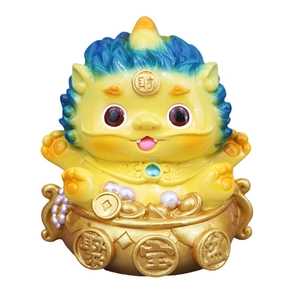 Cute yellow Pixiu figurine sitting in a golden treasure bowl with lucky ingots