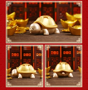 Close-up of golden turtle incense burner with engraved fortune character on back