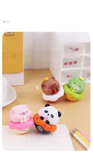 Close-up of cute animal desk tumblers with donut bases on a professional workspace