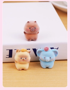 Detailed view of flocked mini animal figurines including a capybara, cat and elephant on a desk