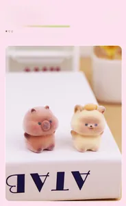 Close-up of cute flocked animal figurines in brown and yellow with soft velvet texture