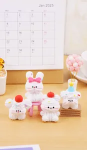 Detailed view of four cute white animal figurines with cream texture on a desk