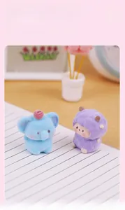 Close-up of cute flocked elephant and purple figure figurines on a desk