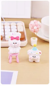 Cute resin bunny and dog figurines on a wooden desk with cozy office decorations