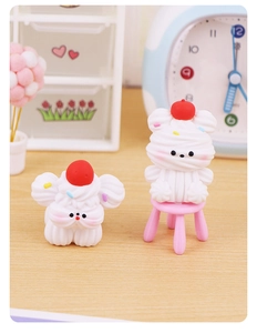 Macro detail of cute resin bear ornaments with cream texture and cherry for cake topper
