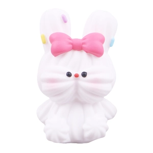 Cute white cream bunny squishy toy with pink bow and colorful sprinkles for desk decor