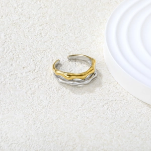 Detailed close-up of a two-tone gold and silver irregular lava wave adjustable ring