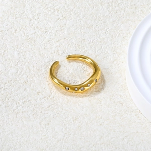 Detail of 18K gold plated irregular wavy ring with sparkling inlaid crystals on stone