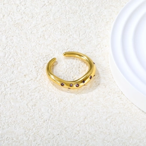 Detailed view of an adjustable gold-plated ring set with round purple gemstones