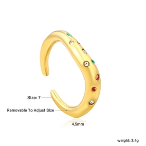 Detail of adjustable gold ring with irregular wave design and colorful cubic zirconia