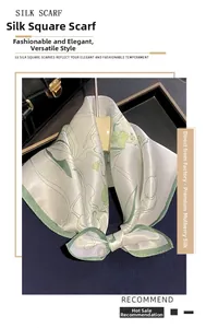 Detail of silk square scarf with light green floral print hanging on a display rack
