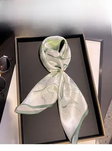 Detail of 100% mulberry silk scarf with green botanical print and pearl ring buckle