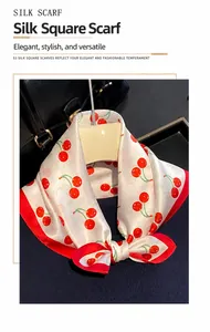 Detail of silk square scarf with red cherry prints and contrasting red rolled edges