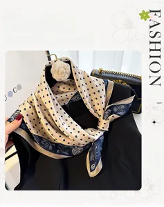 Detail of silk scarf featuring polka dots and paisley patterns on a black dress