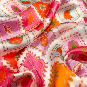 Elegant silk scarf featuring tropical fruit stamp prints in vibrant summer colors