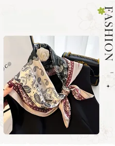 Detail of vintage paisley silk scarf styled on neck with elegant floral brooch