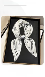 Detail of silk-like neckerchief with black paisley print and white polka dot border