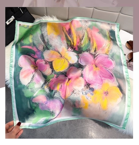 Close-up of oil painting floral print on faux silk square scarf with hand-rolled edges