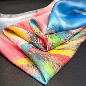 Macro shot of colorful oil painting floral print on silky fabric with soft glossy drapes