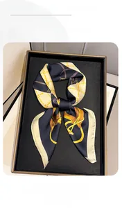 Detail of luxury chain print silk scarf with vintage equestrian pattern in a gift box