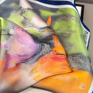 Close-up of oil painting style floral silk scarf with high-saturation colors and rolled edges