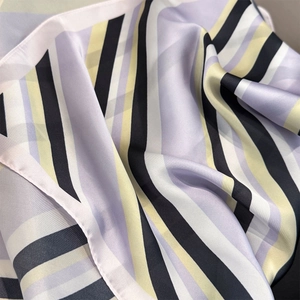 Detailed view of striped satin square scarf with smooth texture and elegant drape
