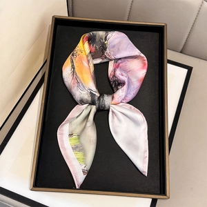 Artistic oil painting floral silk scarf tied in a bow on luxury display tray