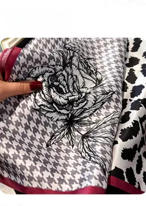 Detailed view of mulberry silk scarf with houndstooth print and elegant floral patterns