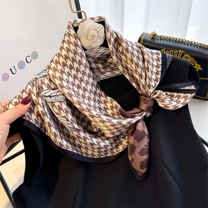 Detail view of silk scarf featuring houndstooth, leopard print, and branch line designs
