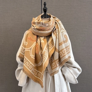Detail of ginger and cream jacquard scarf with Greek fret patterns and fringe edges