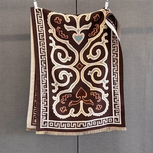 Ethnic style knitted scarf with paisley heart patterns and classic tassel details