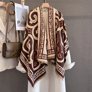 Close-up of retro brown geometric jacquard scarf with decorative fringe details