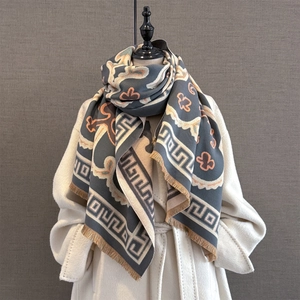 Close-up of thick cashmere-like shawl with Greek fret pattern and short tassel edges