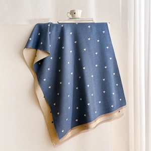 Blue-grey cashmere-like reversible heart pattern scarf with tassels on white surface