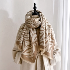 Thick winter scarf with retro floral print and fringe, styled on a beige wool coat