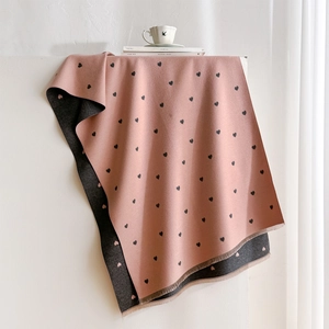 Close-up of double-sided heart pattern cashmere-like scarf with delicate short fringes