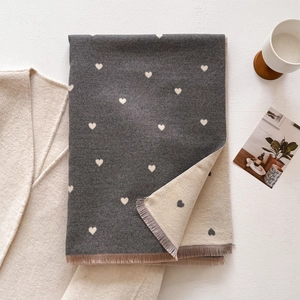 Close-up of double-sided heart pattern cashmere scarf with delicate fringed edges