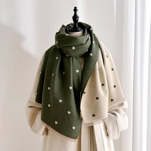 Detail of double-sided heart pattern cashmere-like scarf with soft fringe edges
