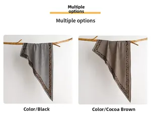 Detail of plaid scarves with paisley borders in black and cocoa brown on branches