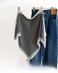 Detailed macro shot of vintage polka dot silk scarf with classic striped border detail