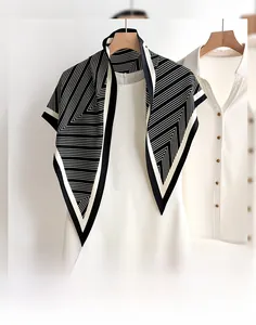 Detail of premium striped triangular shawl with minimalist black and white geometric pattern