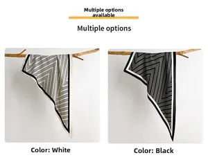 Detailed view of striped triangular silk scarf in black and white with V-shaped patterns