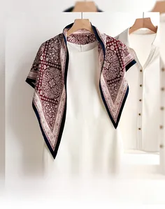 Detail of burgundy paisley triangle scarf draped over a dress showing smooth texture