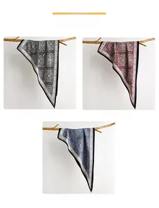 Three-color paisley mandala silk scarves in black, red, and blue displayed on branches
