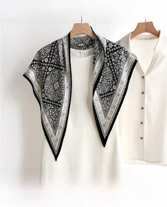 Detail of classic black and white paisley silk scarf paired with a white dress