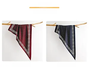 Detailed close-up of vintage geometric silk scarves in red and navy blue on a branch